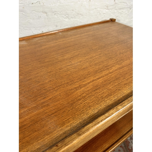 132 - A mid 20th century teak two tier tea trolley - approx. 66cm high x 46cm wide x 71cm long