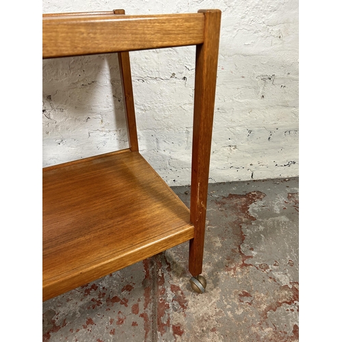 132 - A mid 20th century teak two tier tea trolley - approx. 66cm high x 46cm wide x 71cm long