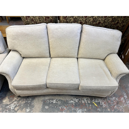 133 - A fabric upholstered three piece lounge suite comprising three seater sofa and two armchairs