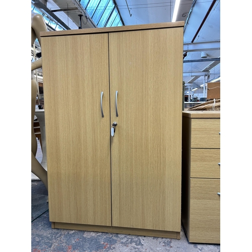 142 - Two pieces of modern oak effect office furniture, one two door cabinet and one three drawer filing c... 