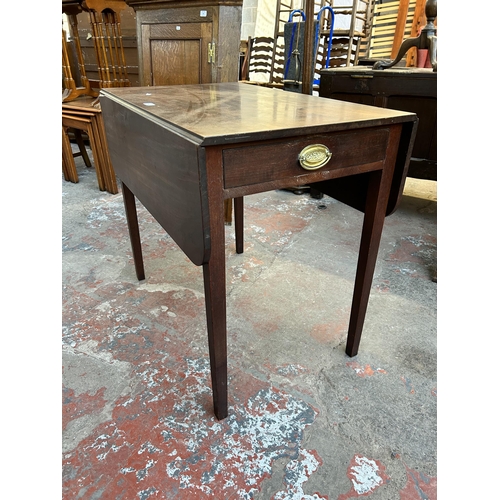 60 - An early 19th century mahogany drop leaf Pembroke table with single drawer and tapering supports - a... 