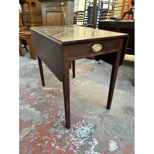 60 - An early 19th century mahogany drop leaf Pembroke table with single drawer and tapering supports - a... 