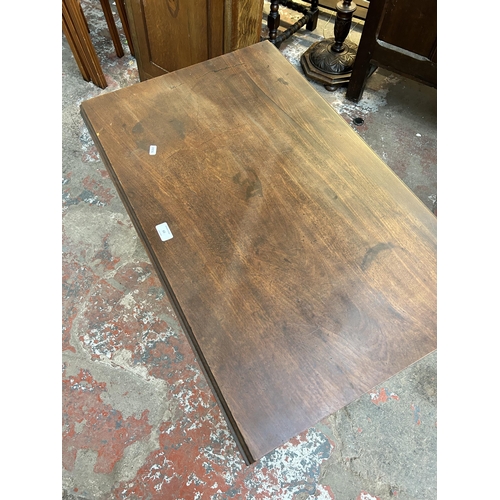 60 - An early 19th century mahogany drop leaf Pembroke table with single drawer and tapering supports - a... 