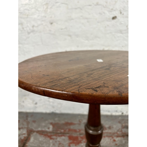 67 - A 19th century oak tilt top table on tripod pedestal support - approx. 86cm high x 44cm wide x 41cm ... 