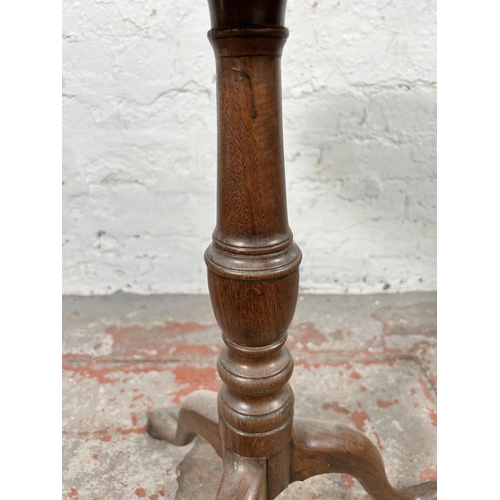 67 - A 19th century oak tilt top table on tripod pedestal support - approx. 86cm high x 44cm wide x 41cm ... 