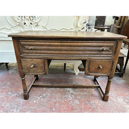 68 - A Goodalls of Manchester oak writing desk - approx. 77cm high x 107cm wide x 53cm deep