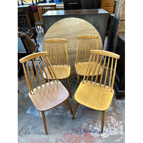 78 - A Dinette wood effect drop leaf circular dining table and four Ercol style beech dining chairs