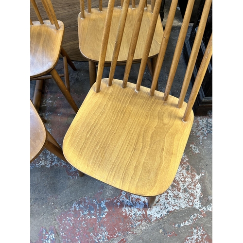 78 - A Dinette wood effect drop leaf circular dining table and four Ercol style beech dining chairs