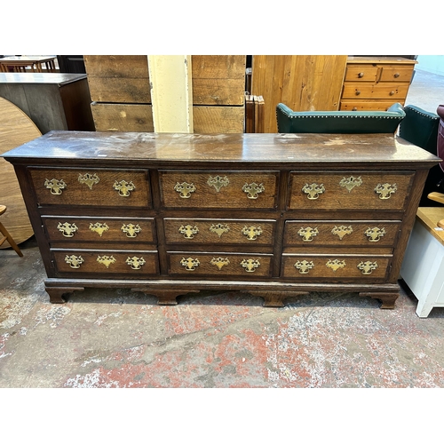 79 - A George III Lancashire oak and mahogany crossbanded sideboard with five drawers, two cupboard doors... 