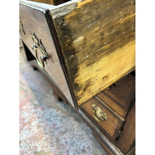 79 - A George III Lancashire oak and mahogany crossbanded sideboard with five drawers, two cupboard doors... 