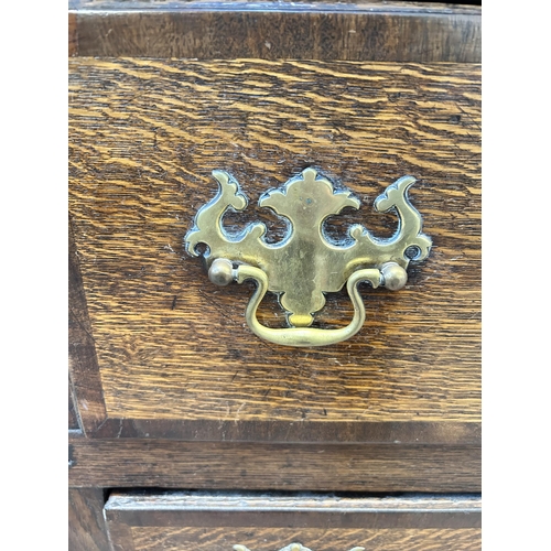 79 - A George III Lancashire oak and mahogany crossbanded sideboard with five drawers, two cupboard doors... 