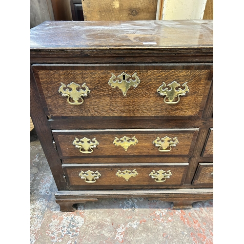 79 - A George III Lancashire oak and mahogany crossbanded sideboard with five drawers, two cupboard doors... 