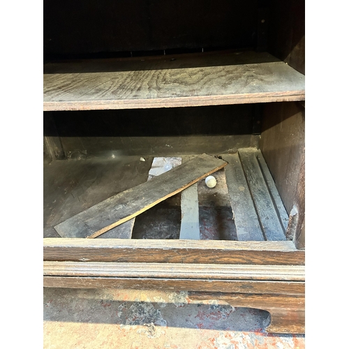 79 - A George III Lancashire oak and mahogany crossbanded sideboard with five drawers, two cupboard doors... 