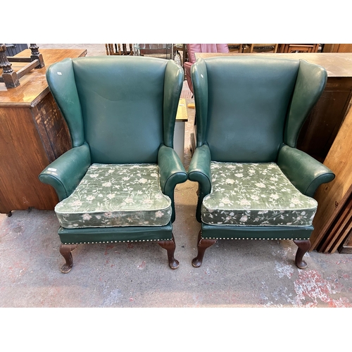 84 - A pair of Parker Knoll PK720/745/1013 green vinyl upholstered wingback armchairs