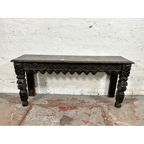 88 - A Victorian Gothic Revival heavily carved oak bench/window seat - approx. 49cm high x 107cm wide x 2... 