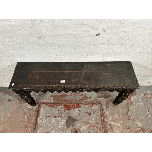 88 - A Victorian Gothic Revival heavily carved oak bench/window seat - approx. 49cm high x 107cm wide x 2... 