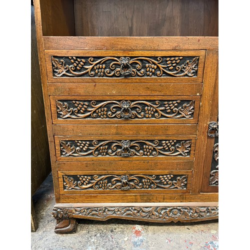 53 - A carved oak cabinet with single cupboard door and four drawers - approx. 87cm high x 71cm wide x 35... 