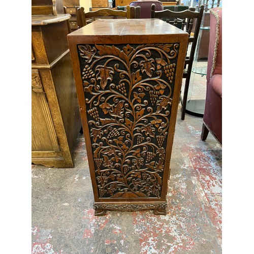 53 - A carved oak cabinet with single cupboard door and four drawers - approx. 87cm high x 71cm wide x 35... 