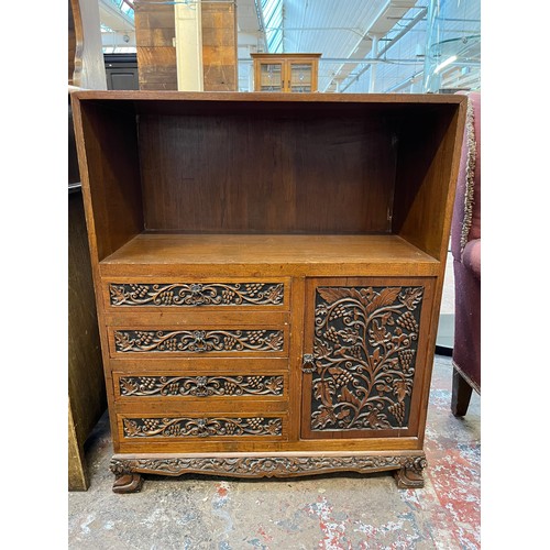 53 - A carved oak cabinet with single cupboard door and four drawers - approx. 87cm high x 71cm wide x 35... 