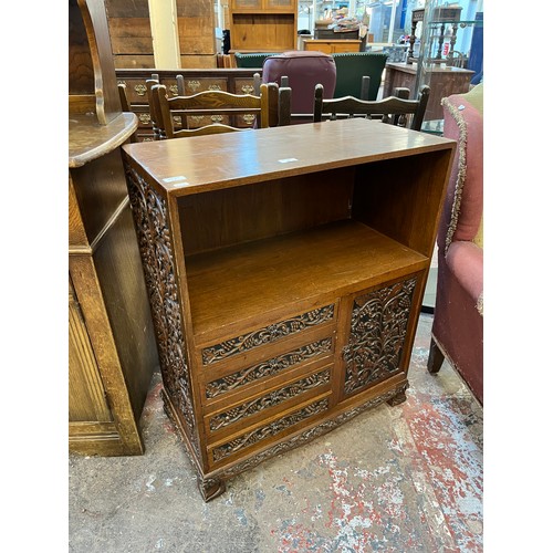 53 - A carved oak cabinet with single cupboard door and four drawers - approx. 87cm high x 71cm wide x 35... 