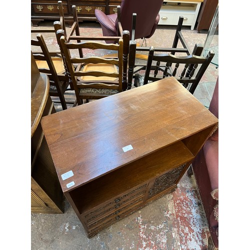 53 - A carved oak cabinet with single cupboard door and four drawers - approx. 87cm high x 71cm wide x 35... 