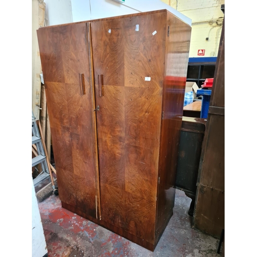 170 - An Art Deco walnut double wardrobe with fitted interior