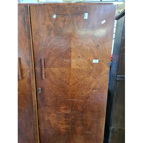 170 - An Art Deco walnut double wardrobe with fitted interior