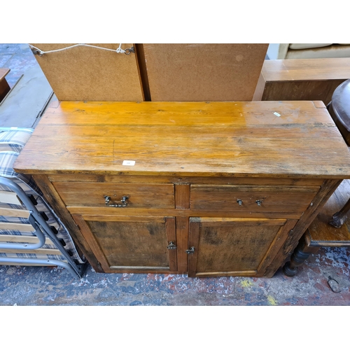 159 - A mid 20th century pine sideboard with two drawers and two cupboard door - approx. 90cm high x 107cm... 