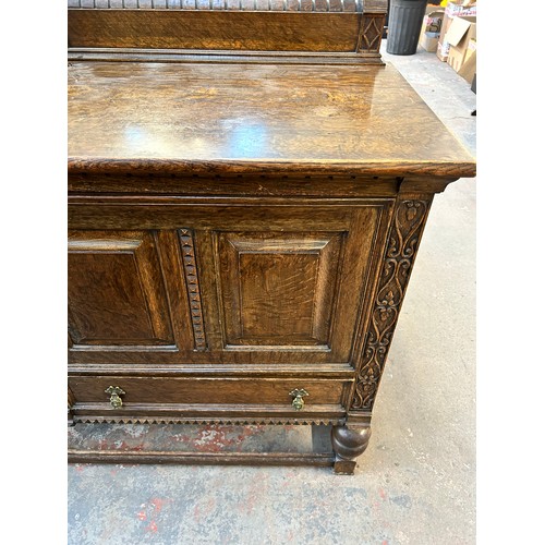 147 - An early 20th century carved oak sideboard with baluster supports and gallery back - approx. 108cm h... 