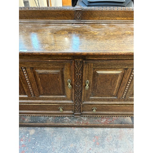 147 - An early 20th century carved oak sideboard with baluster supports and gallery back - approx. 108cm h... 