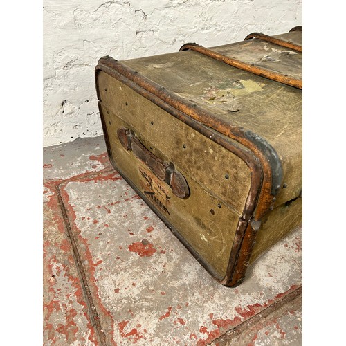 149 - An early 20th century wooden banded canvas travel trunk - approx. 37cm high x 92cm wide x 59cm deep