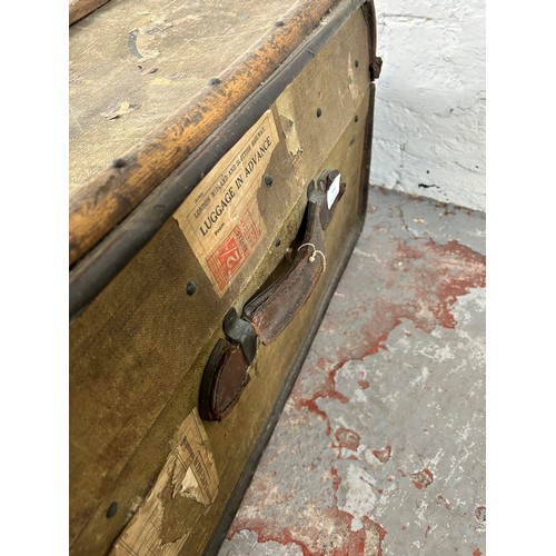 149 - An early 20th century wooden banded canvas travel trunk - approx. 37cm high x 92cm wide x 59cm deep