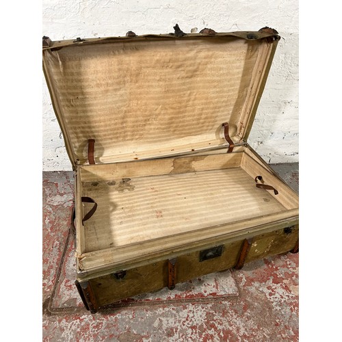 149 - An early 20th century wooden banded canvas travel trunk - approx. 37cm high x 92cm wide x 59cm deep