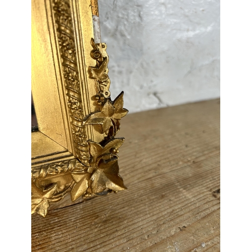 180 - A late 19th/early 20th century gilt framed bevelled edge wall mirror with foliate design - approx. 4... 