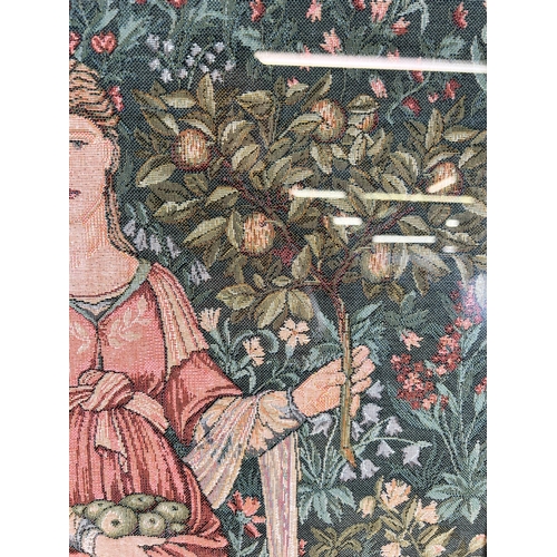 192 - A framed Arts and Crafts style tapestry of a lady holding apples - approx. 76cm high x 48cm wide