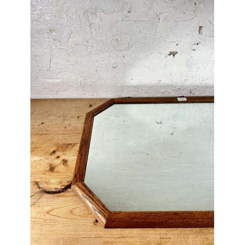 214A - An early 20th century oak framed octagonal wall mirror - approx. 56cm high x 80cm wide