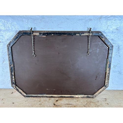 214A - An early 20th century oak framed octagonal wall mirror - approx. 56cm high x 80cm wide