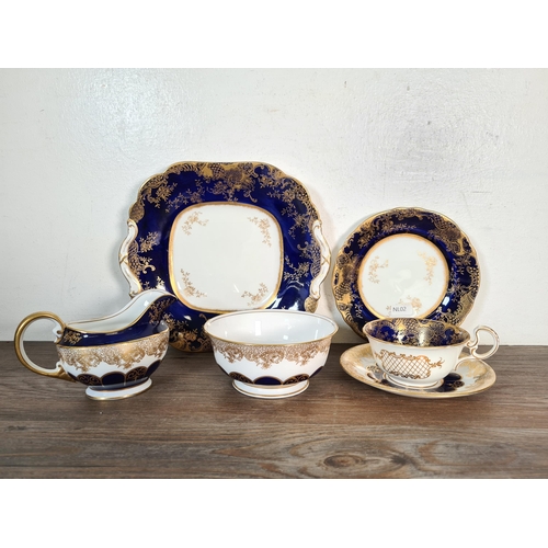 327 - Seventy six pieces of Aynsley cobalt blue and gold china