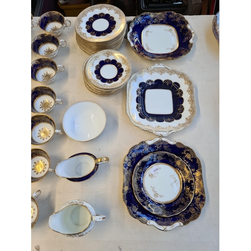 327 - Seventy six pieces of Aynsley cobalt blue and gold china