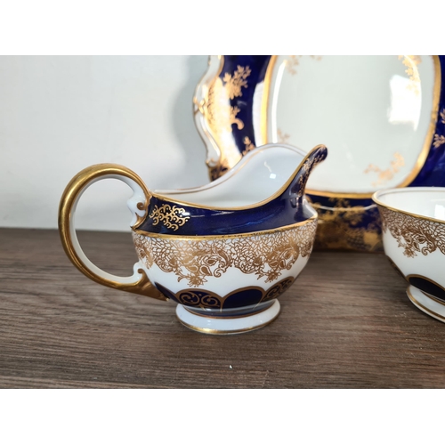 327 - Seventy six pieces of Aynsley cobalt blue and gold china