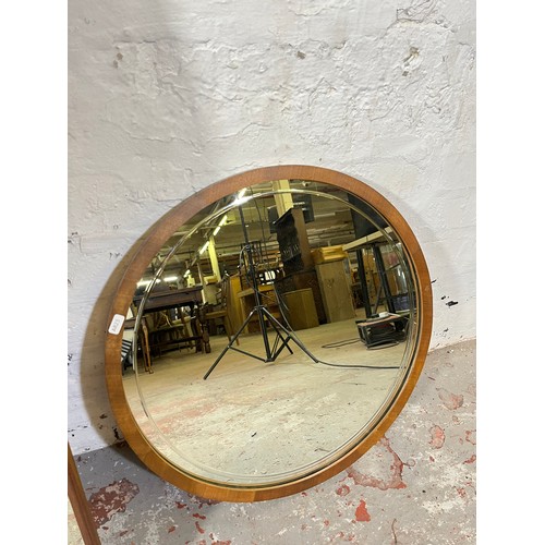 163 - Three mid 20th century teak framed wall mirrors, two 125cm x 40cm and one 54cm diameter