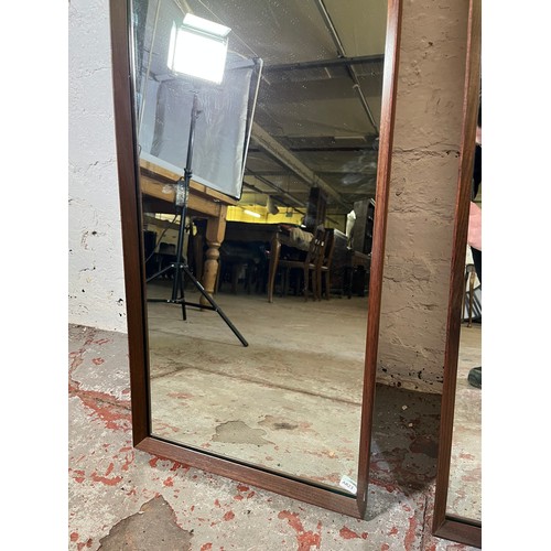 163 - Three mid 20th century teak framed wall mirrors, two 125cm x 40cm and one 54cm diameter