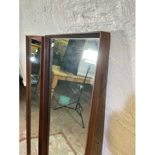 163 - Three mid 20th century teak framed wall mirrors, two 125cm x 40cm and one 54cm diameter