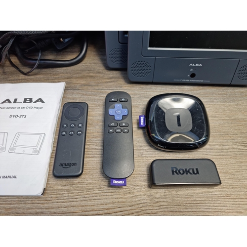 749 - A collection of items to include Roku media streamer, cased Alba portable DVD player, boxed amplifie... 