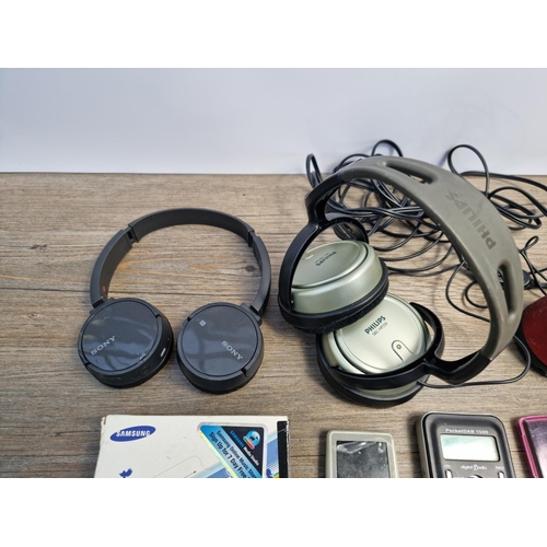 751 - A collection of headphones and portable media players to include boxed Samsung K3, Pure PocketDAB 15... 