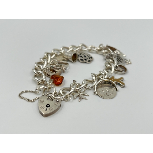 1156 - A sterling silver charm bracelet - approx. gross weight 38.5 grams