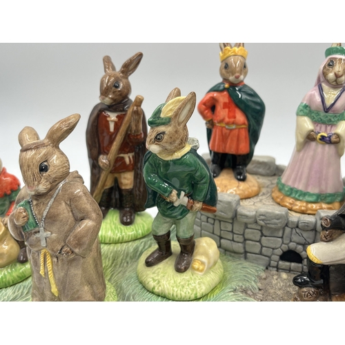 252 - Eight Royal Doulton The Robin Hood Collection Bunnykins figurines together with display base