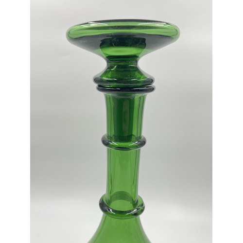 259 - A green glass decanter - approx. 32cm high