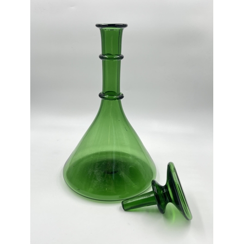 259 - A green glass decanter - approx. 32cm high