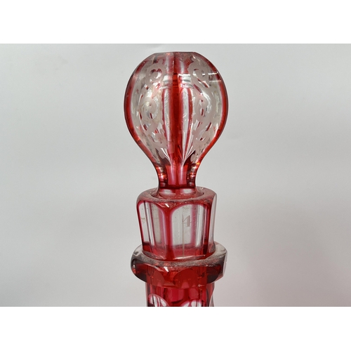 267 - A pair of cranberry glass decanters - approx. 30cm high